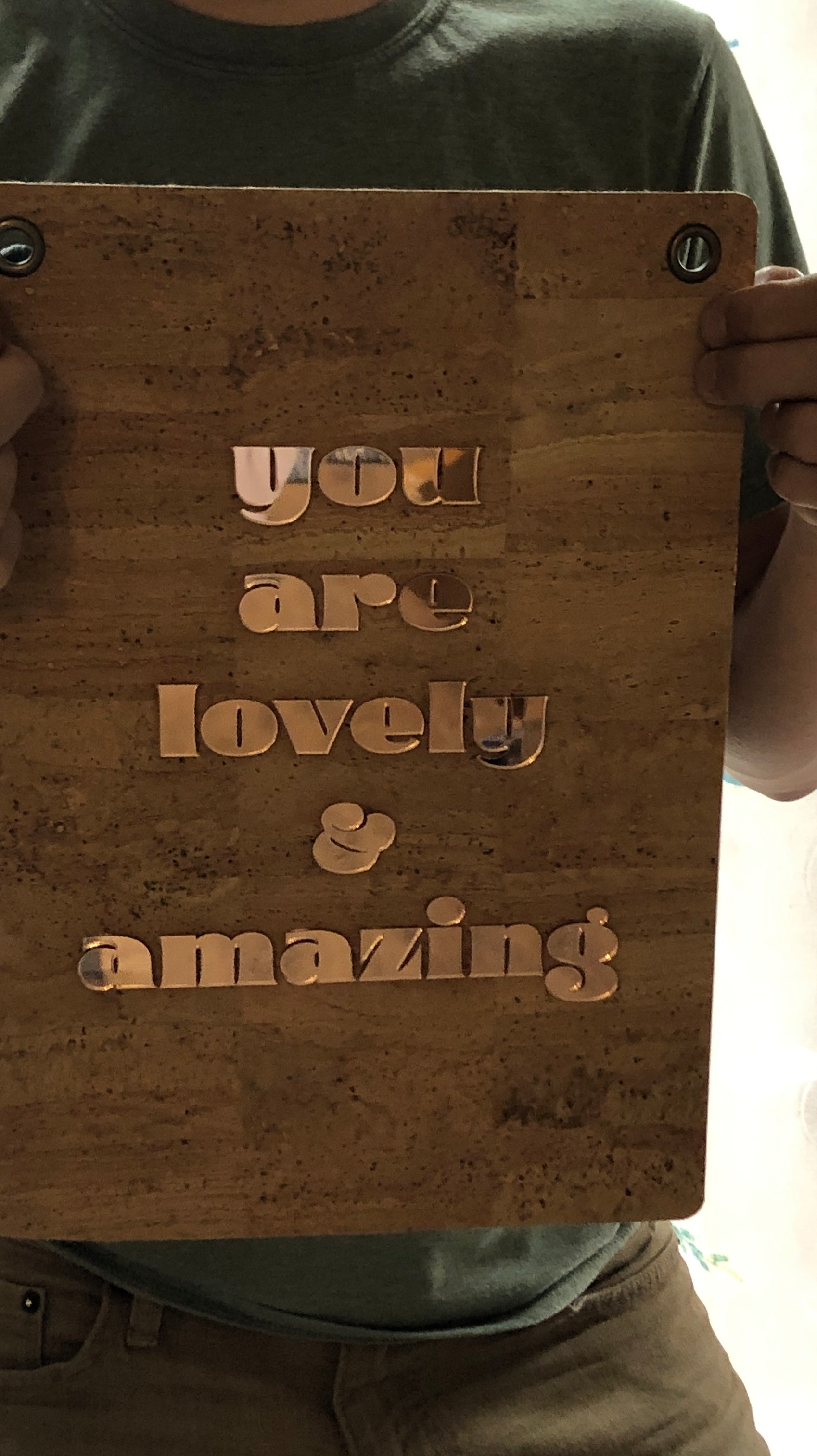 person holding you are lovely and amazing affirmation banner