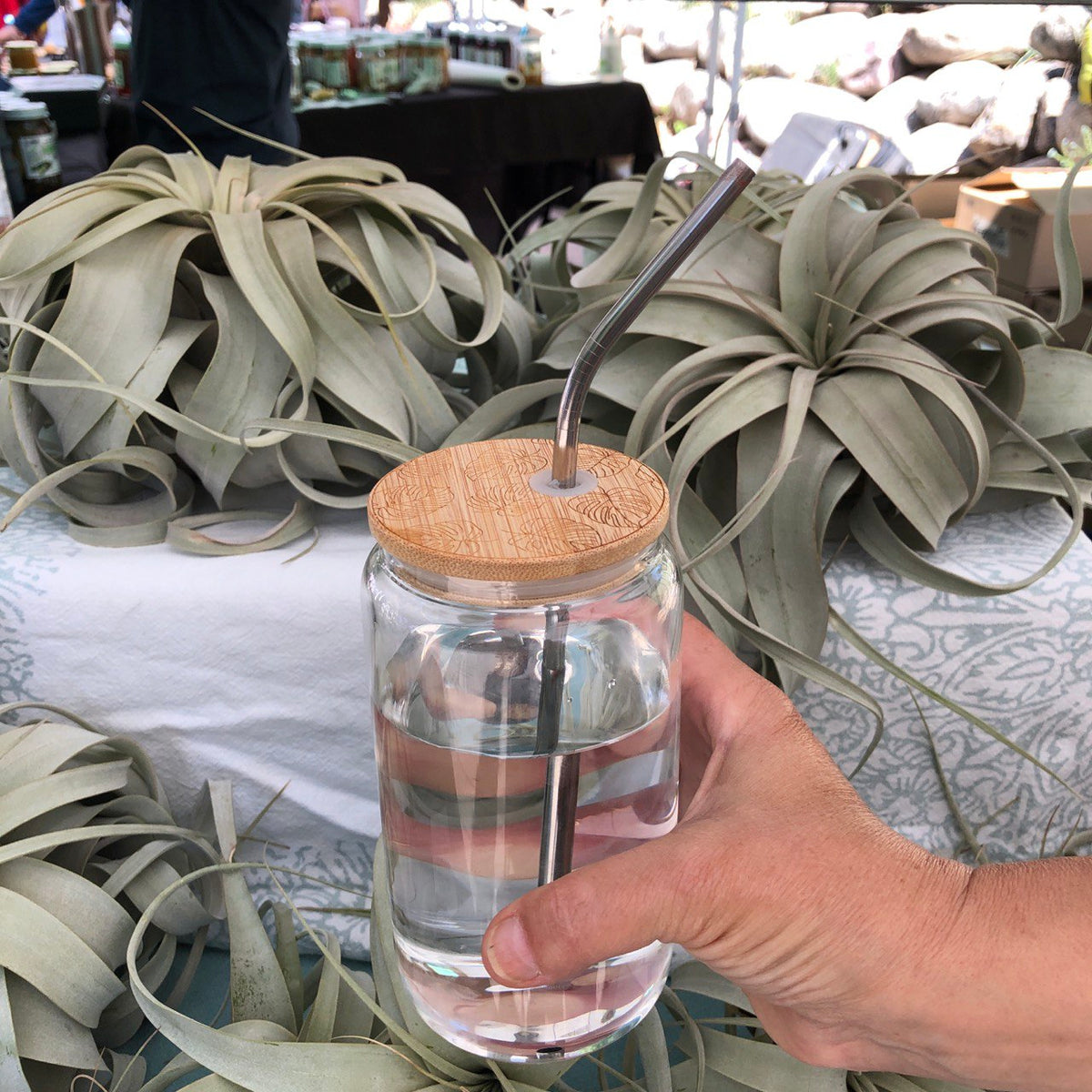 Glass drinking jar with lid and straw