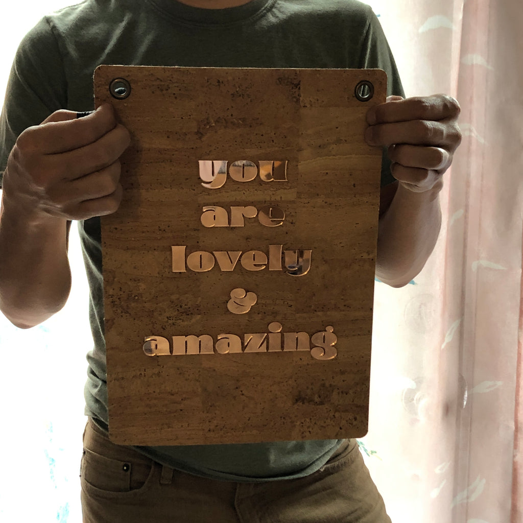 person holding you are lovely and amazing affirmation banner